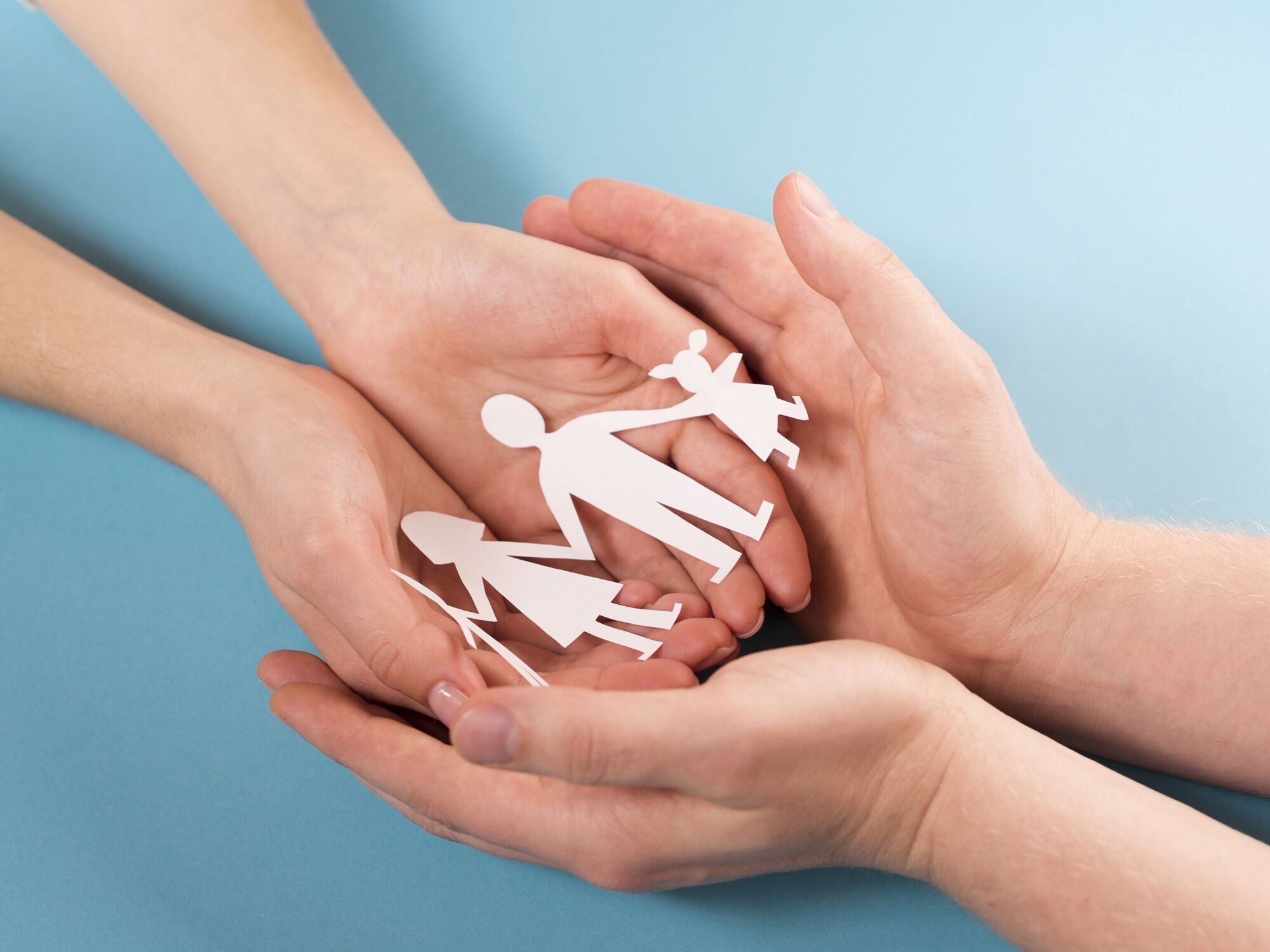people-holding-in-hands-cute-paper-family